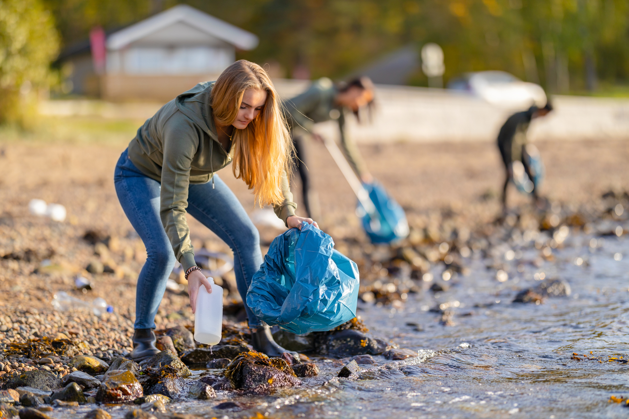 Ungdommer plukker søppel på en strand
