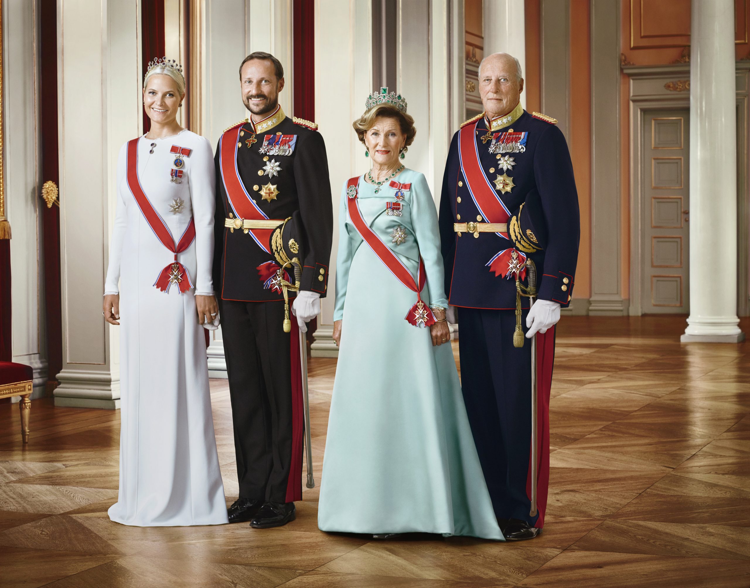 Offisielt bilde av Deres Majesteter Kongen og Dronningen, Deres Kongelige Høyheter Kronprinsen og Kronprinsessen. Kongen og Kronprinsen i uniform, og Dronningen og Kronprinsessen i gallakjoler.
