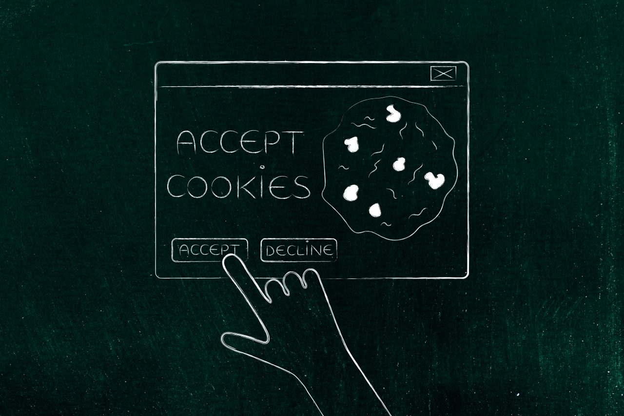 Tegning av en hånd som klikker på accept cookies på en datamaskin.