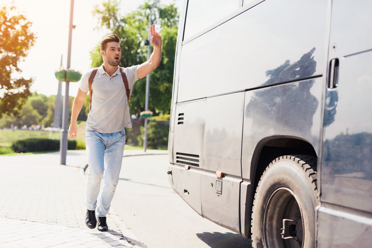 En gutt som prøver å få bussen til å stoppe