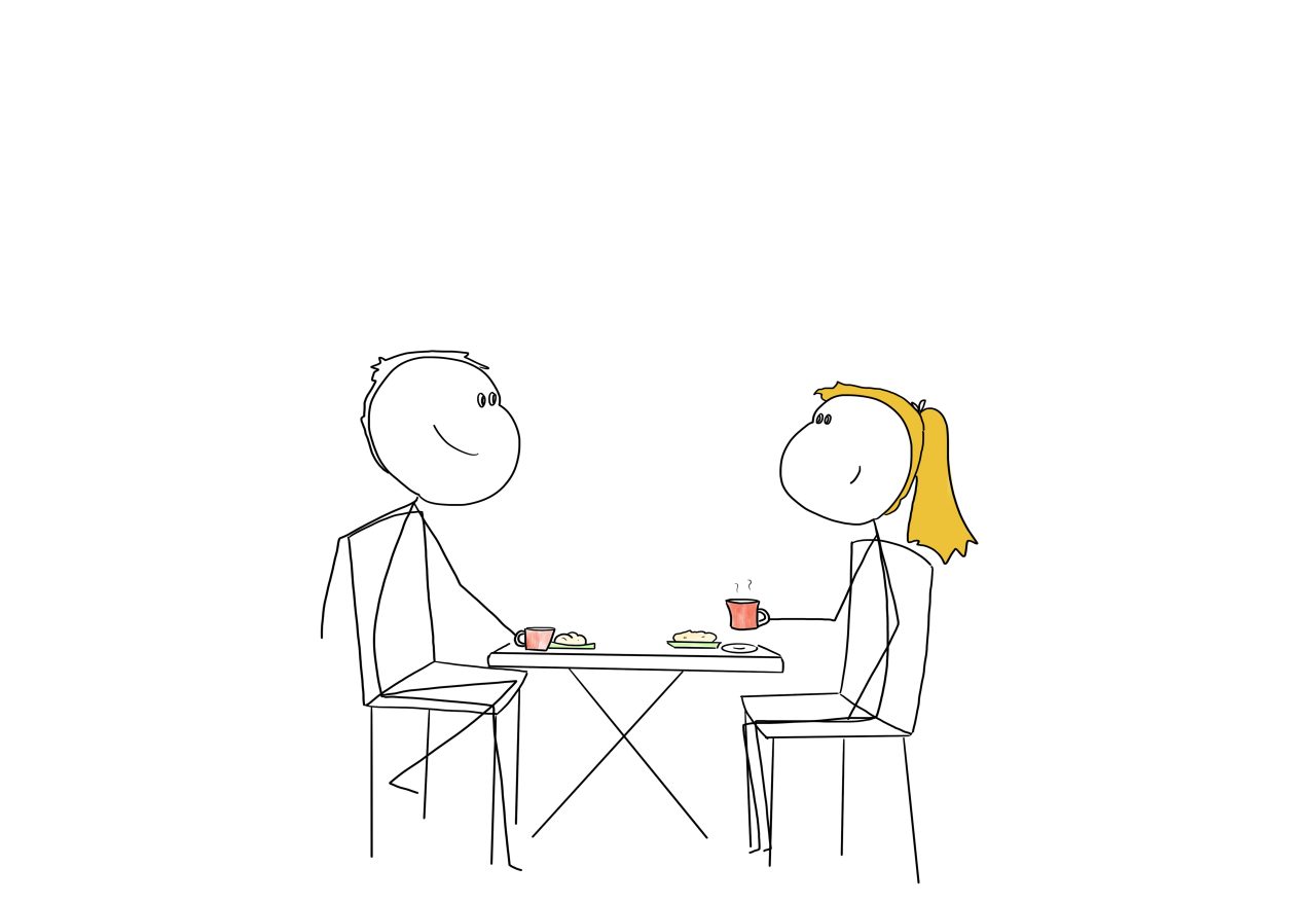 Two people sitting at a table having a coffee, looking happy.