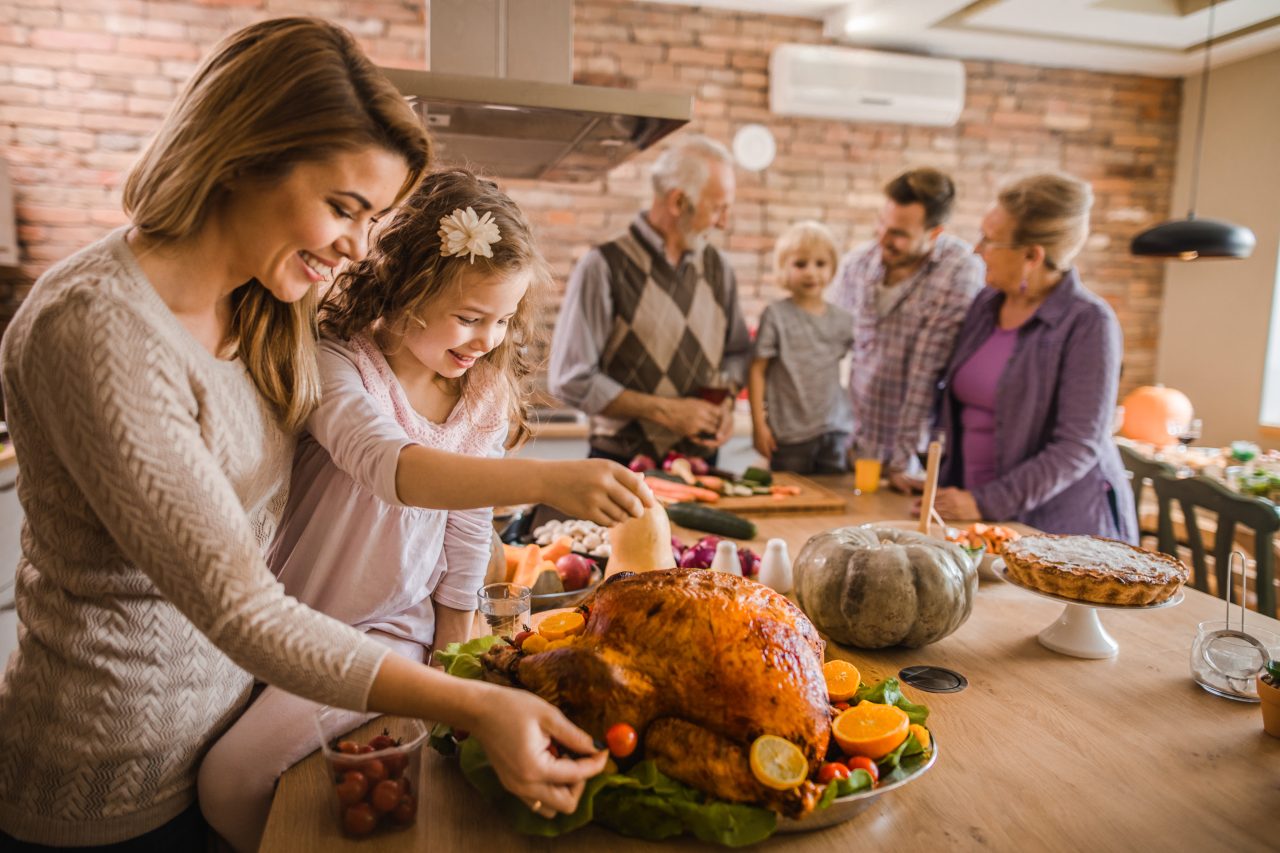 Mor og datter forbereder en kalkun til Thanksgiving-middag med familien.