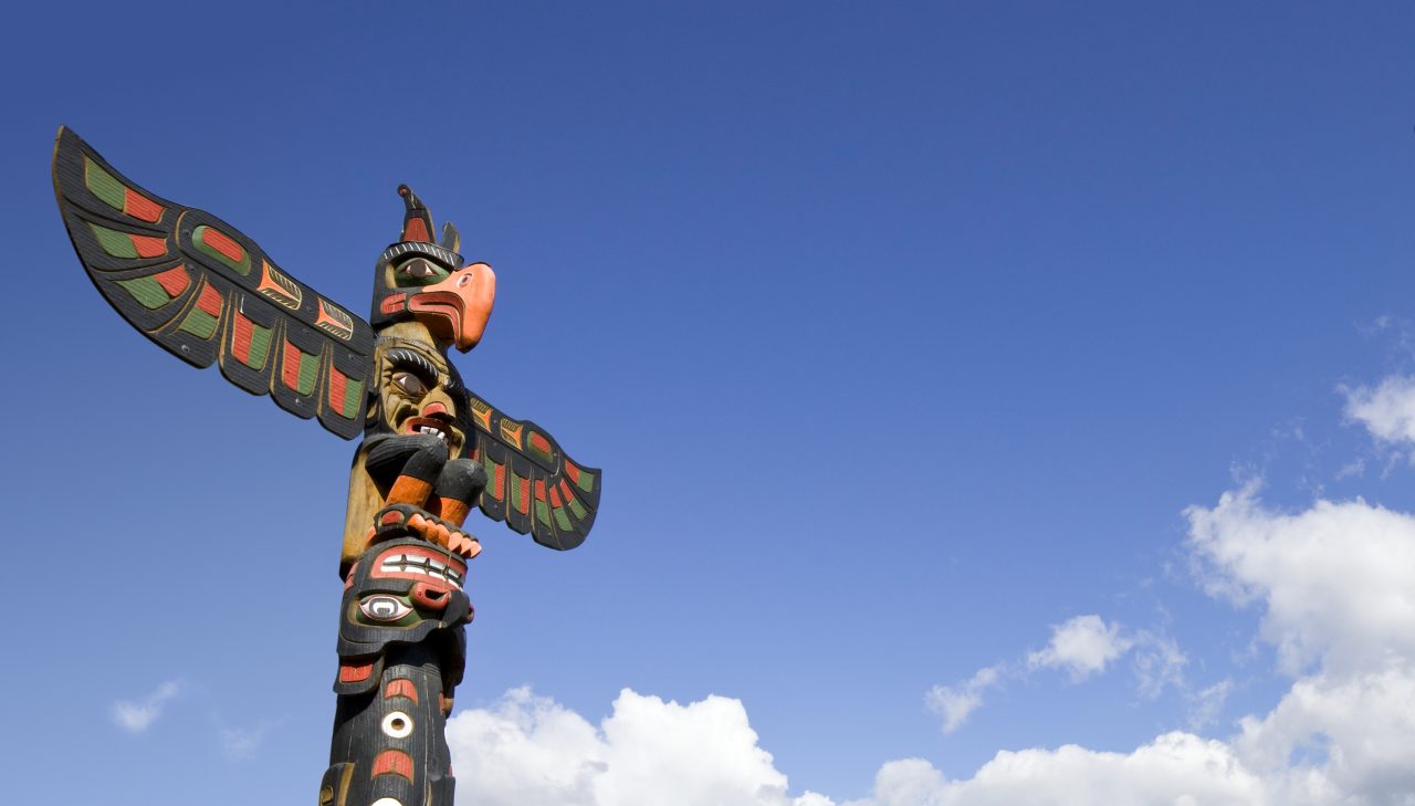 A totem pole against a blue sky